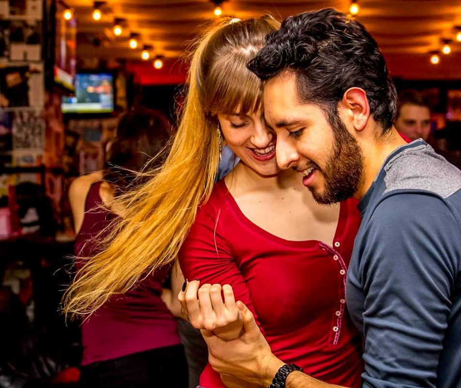 Advanced couple dancing Salsa at a Social organized by Dance4Water.
