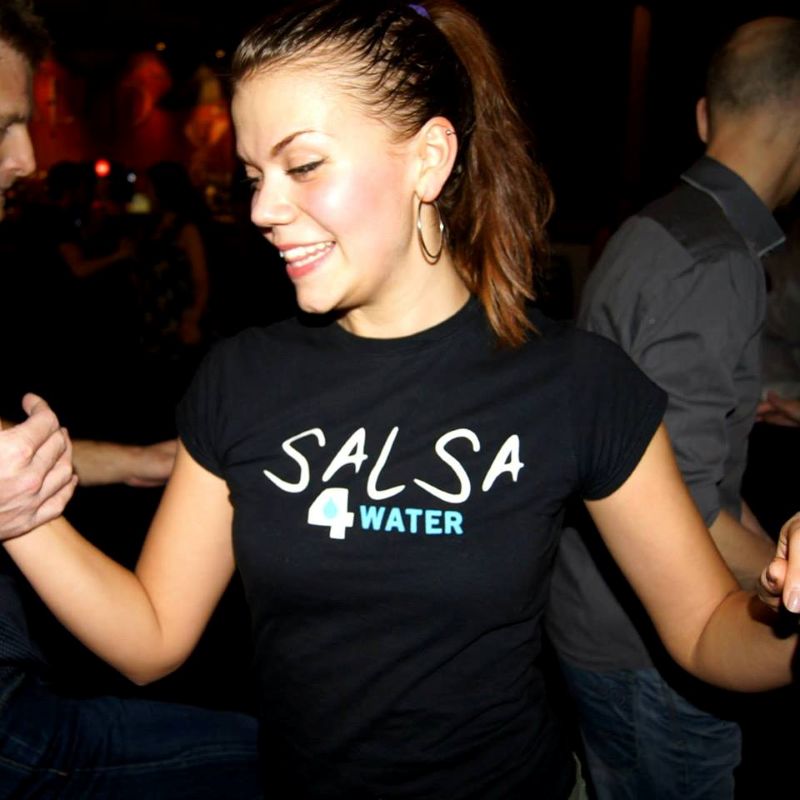 A female teacher of Dance4Water dancing at a social.