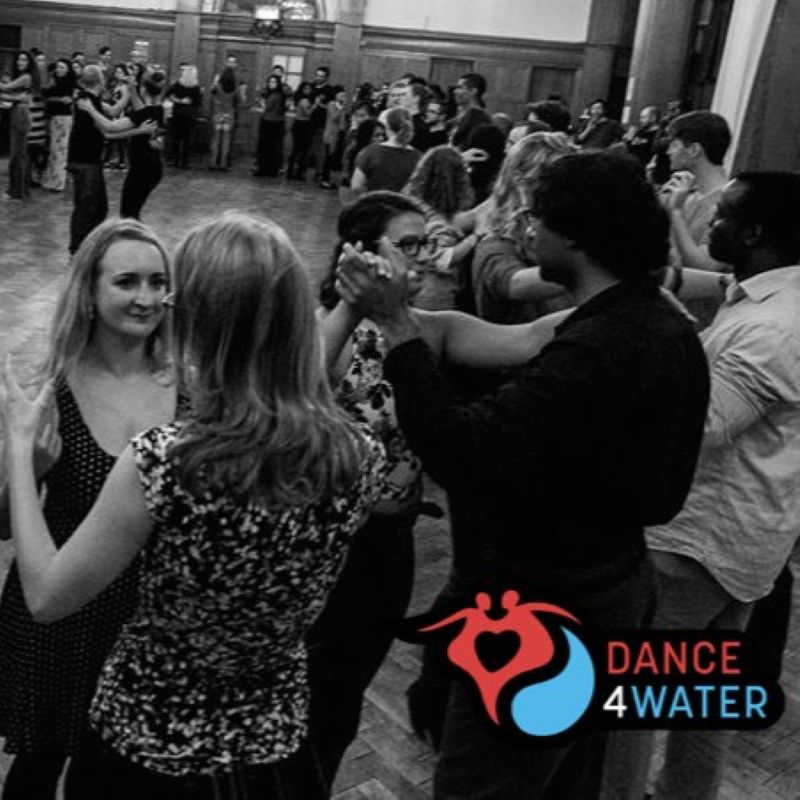 Picture of a group of people dancing Salsa in a Rueda.