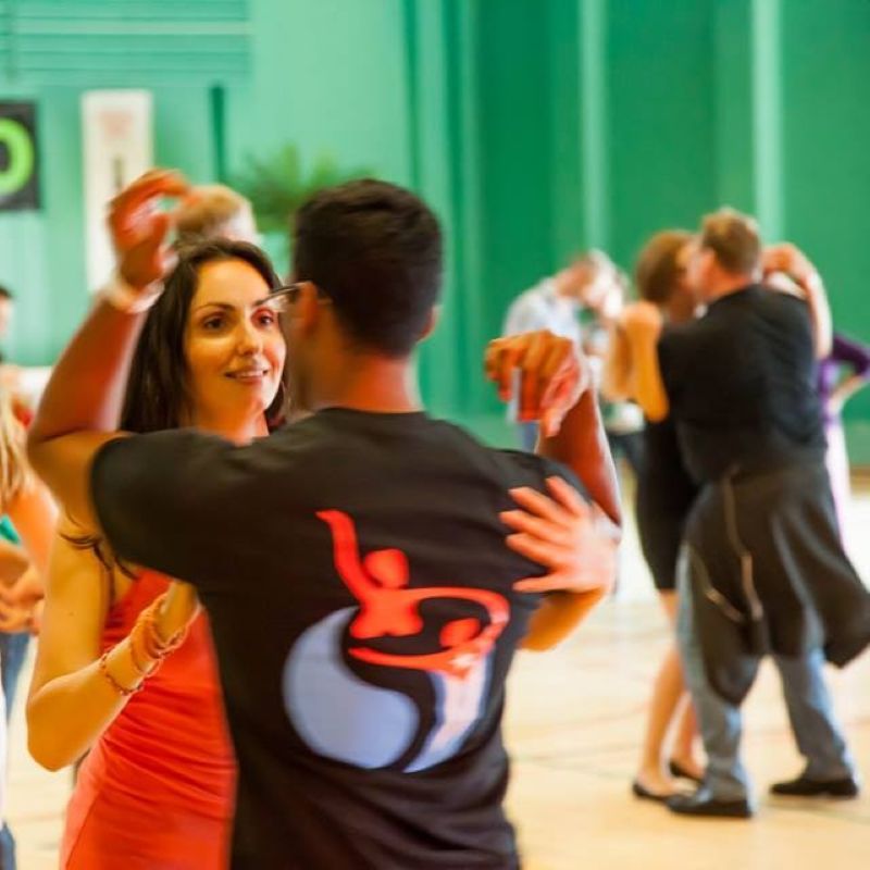 Couple dancing at a Salsa social organized by Dance4Water.